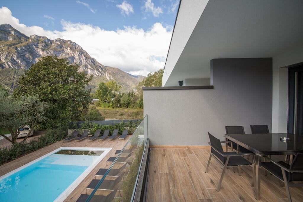 Private balcony with dining table overlooking the pool and mountains
